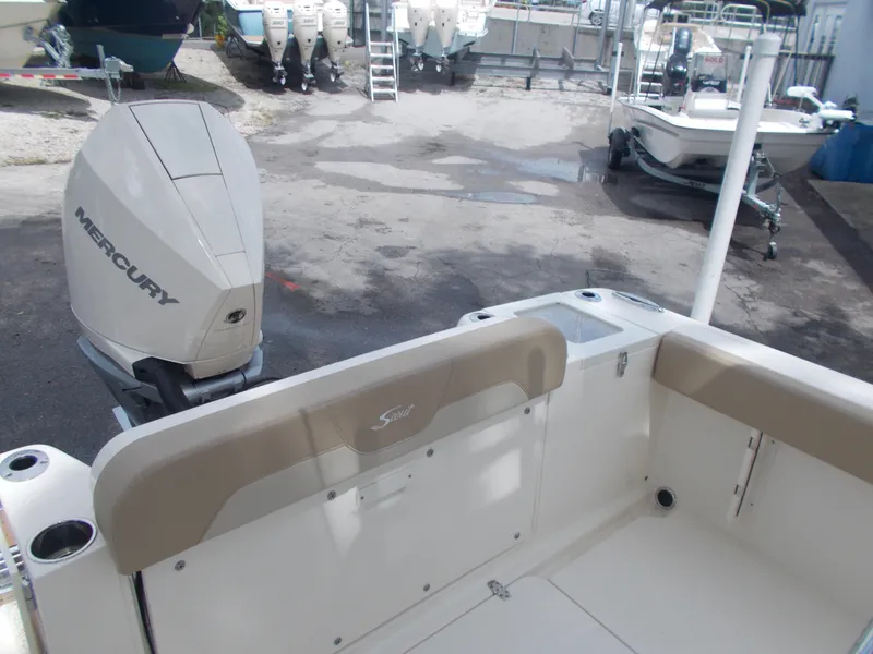 Slide: The Image of 2025 Scout 240 XSF boat with Mercury outboard engine in a marina. - 7