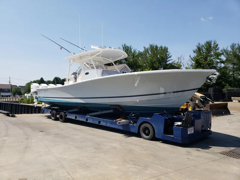 Slide: The Image of 2018 Regulator 41 Center Console boat on a trailer for transport. - 0
