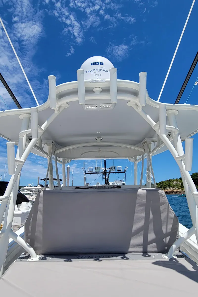 Slide: The Image of 2018 Regulator 41 Center Console boat with radar, under a clear blue sky. - 18