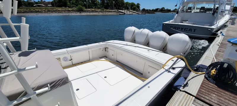 Slide: The Image of 2018 Regulator 41 Center Console boat docked with triple outboard engines. - 19