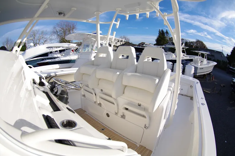 Slide: The Image of 2018 Regulator 41 Center Console boat with white seating and helm station. - 7