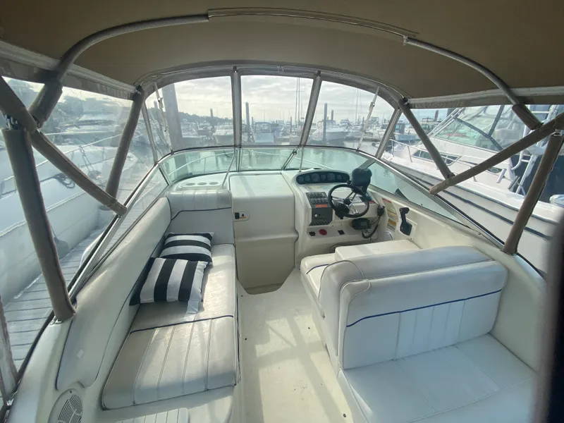 Slide: The Image of Interior view of 1996 Sea Ray 250 Sundancer boat with seating and helm. - 3