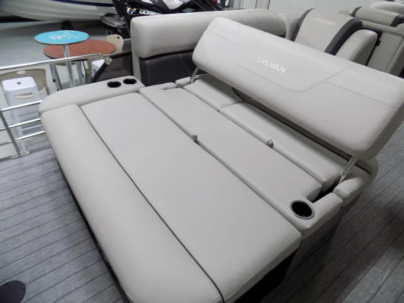 Slide: The Image of 2023 Sylvan Mirage X X3 CLZ boat interior with beige seating and cup holders. - 10