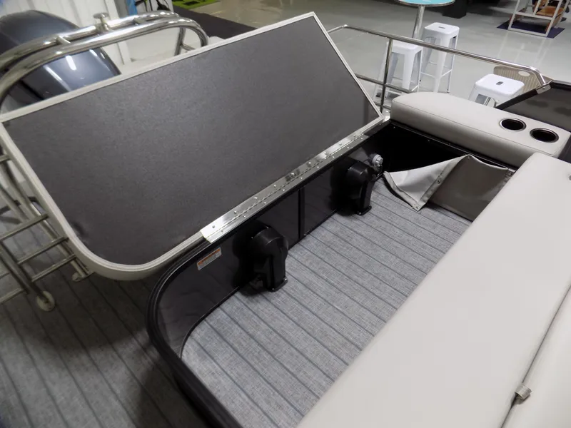 Slide: The Image of 2023 Sylvan Mirage X X3 CLZ boat interior with open storage compartment and seating. - 11