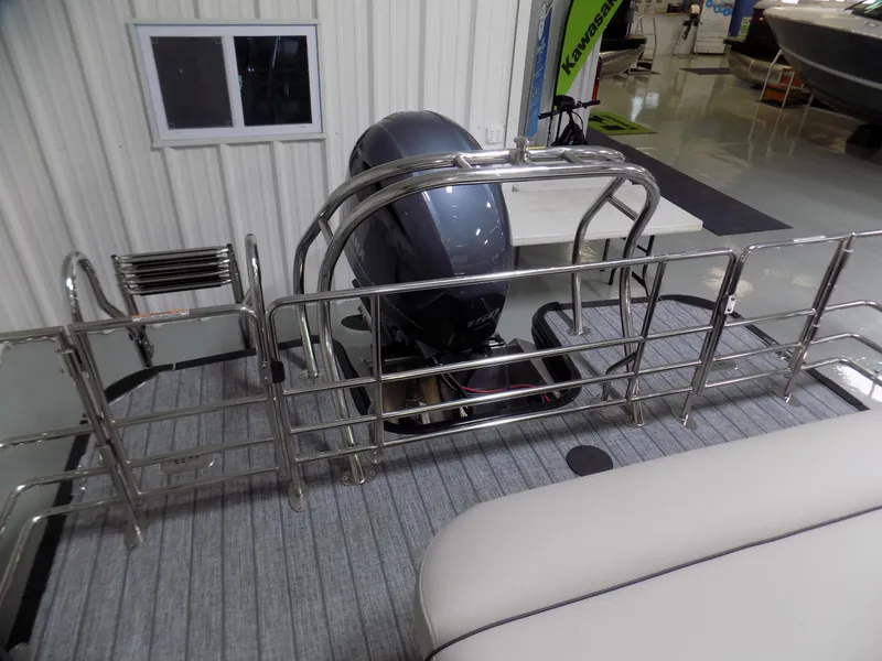 Slide: The Image of 2023 Sylvan Mirage X X3 CLZ pontoon boat with motor and railing in showroom. - 12