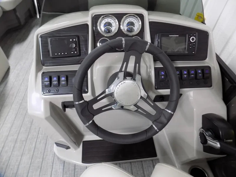 Slide: The Image of 2023 Sylvan Mirage X X3 CLZ boat dashboard with steering wheel and control panel. - 7