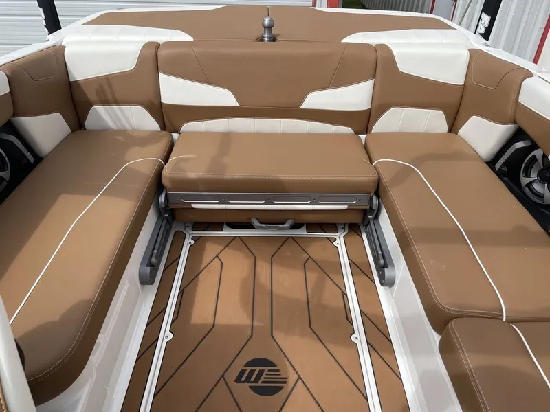 Slide: The Image of 2021 Malibu 22 LSV boat interior with tan and white seating. - 6
