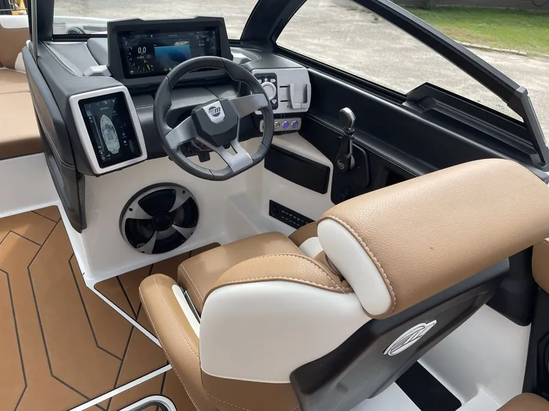 Slide: The Image of 2021 Malibu 22 LSV boat interior with modern dashboard and tan leather seating. - 8