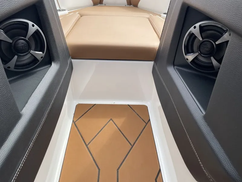 Slide: The Image of Interior of 2021 Malibu 22 LSV boat with speakers and cushioned seating. - 9