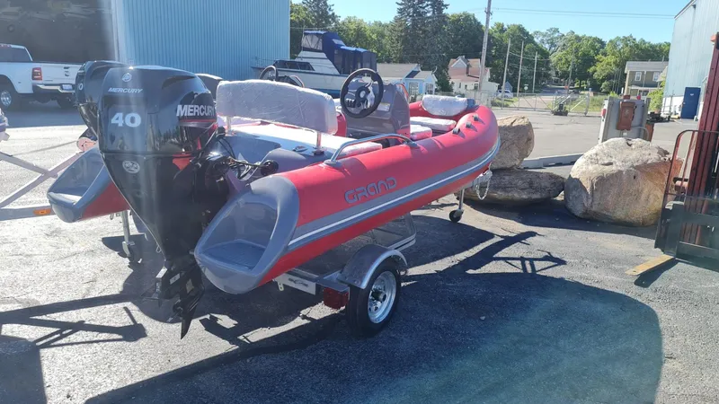 Slide: The Image of 2023 Grand Inflatables G380EF boat with Mercury 40 engine on trailer. - 10