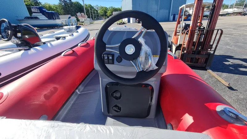 Slide: The Image of 2023 Grand Inflatables G380EF boat with red tubes and steering console. - 17