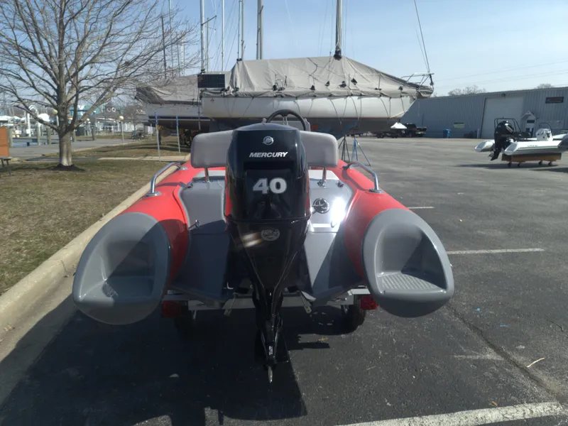Slide: The Image of 2023 Grand Inflatables G380EF with Mercury 40 outboard motor in a parking lot. - 3