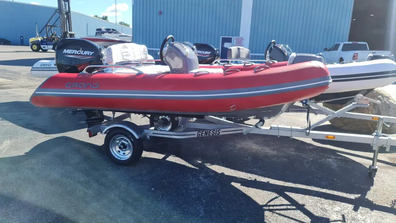 Slide: The Image of 2023 Grand Inflatables G380EF red boat on trailer with Mercury engine. - 9
