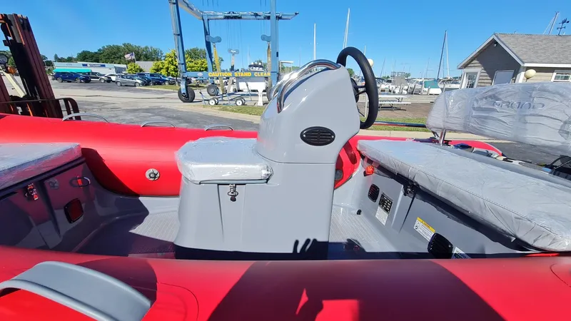 Slide: The Image of 2023 Grand Inflatables G380EF boat interior with red and gray seating. - 14