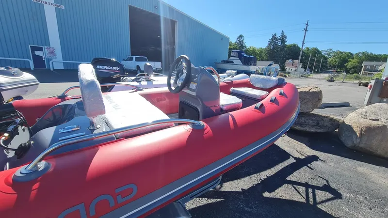 Slide: The Image of 2023 Grand Inflatables G380EF boat in a marina parking lot. - 18