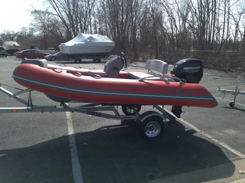 Slide: The Image of 2023 Grand Inflatables G380EF red inflatable boat on trailer with Mercury outboard motor. - 6