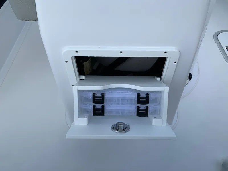 Slide: The Image of 2024 Cape Horn 24 XS boat storage compartment with tackle boxes. - 10