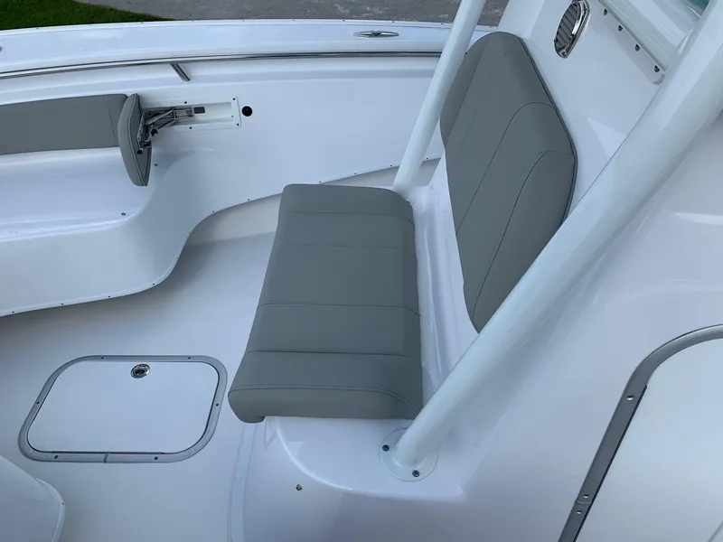 Slide: The Image of 2024 Cape Horn 24 XS boat interior with gray seating and white deck. - 14