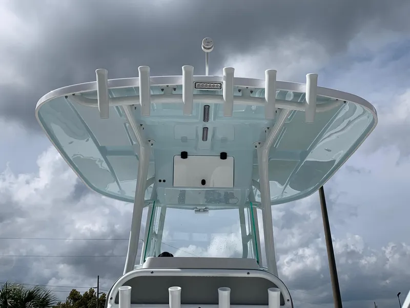 Slide: The Image of 2024 Cape Horn 24 XS boat with T-top and rod holders against cloudy sky. - 4