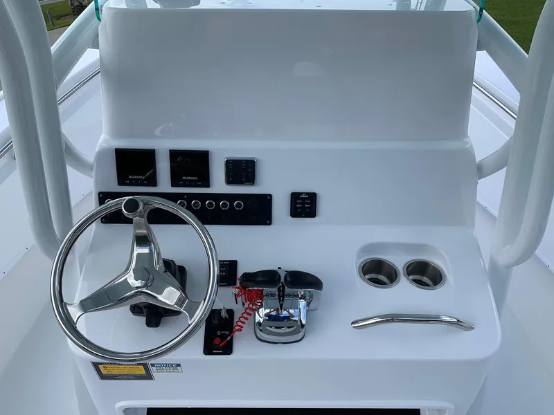 Slide: The Image of 2024 Cape Horn 24 XS boat console with steering wheel and controls. - 8