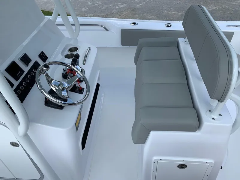 Slide: The Image of 2024 Cape Horn 24 XS boat helm and seating area with modern controls. - 9
