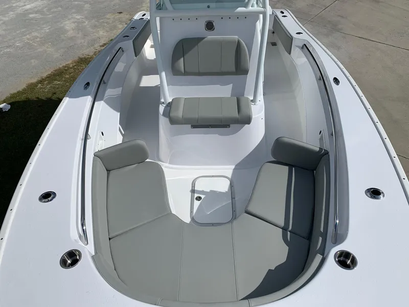 Slide: The Image of 2024 Cape Horn 24 XS boat interior with gray seating and white deck. - 17