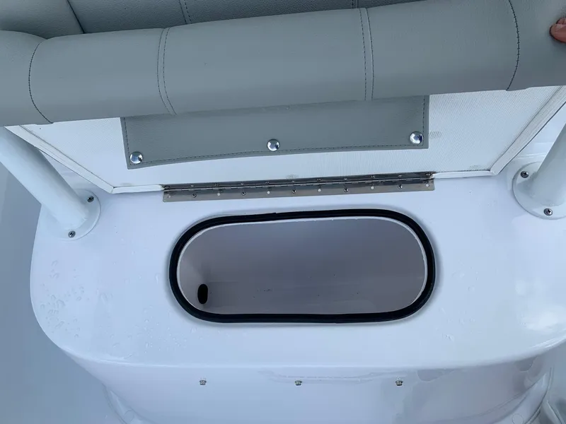 Slide: The Image of 2024 Cape Horn 24 XS boat storage compartment with cushioned seating. - 13