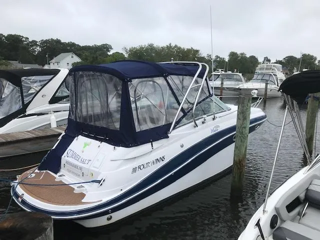 The Image of 2007 Four Winns 278 Vista boat docked in a marina, featuring a blue canopy. - 0