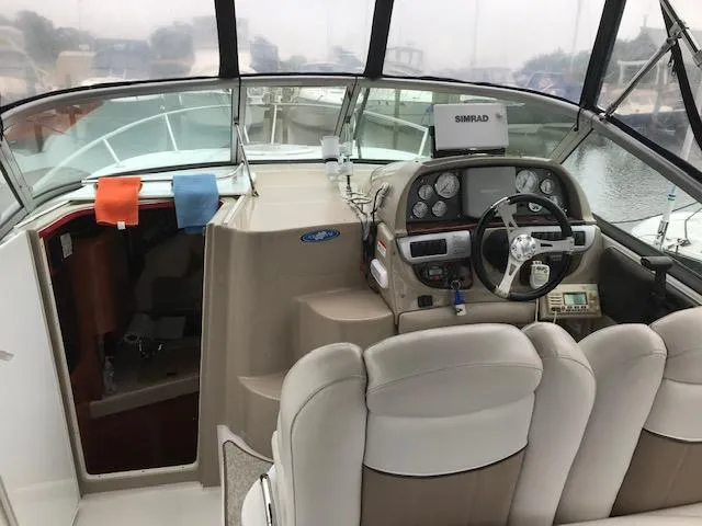 Slide: The Image of 2007 Four Winns 278 Vista boat interior with steering console and cabin entrance. - 5