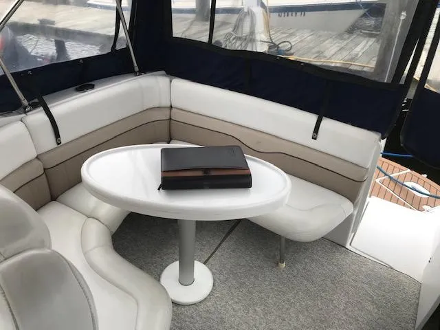 Slide: The Image of 2007 Four Winns 278 Vista boat interior with white seating and table. - 6