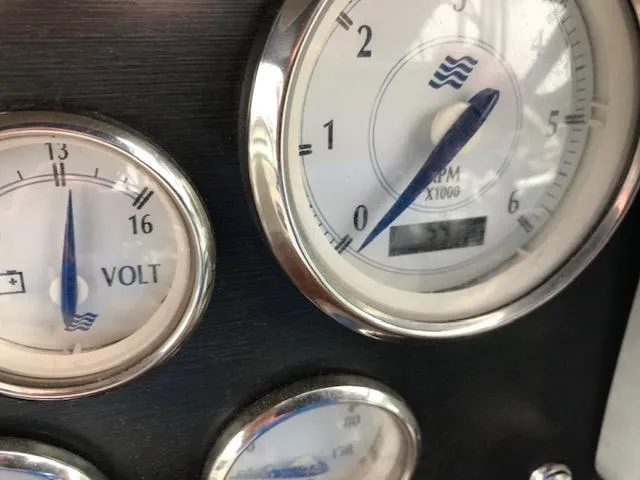 Slide: The Image of Close-up of 2007 Four Winns 278 Vista boat gauges, showing voltmeter and RPM indicators. - 9