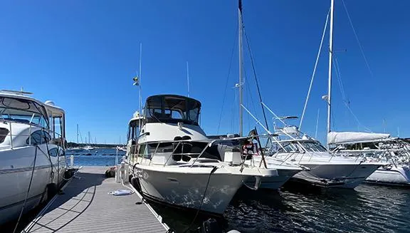 Slide: The Image of 1991 Hatteras 40 Motor Yacht docked at a marina on a sunny day. - 10
