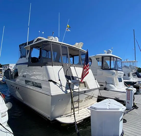 Slide: The Image of 1991 Hatteras 40 Motor Yacht docked at marina, rear view. - 11