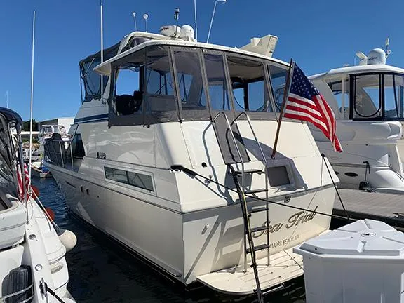 Slide: The Image of 1991 Hatteras 40 Motor Yacht docked with American flag. - 12