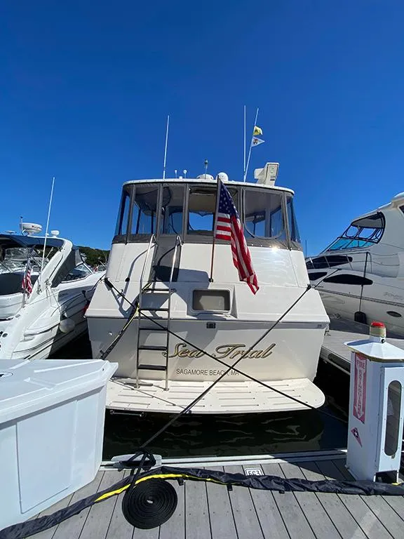 Slide: The Image of 1991 Hatteras 40 Motor Yacht docked at a marina. - 13