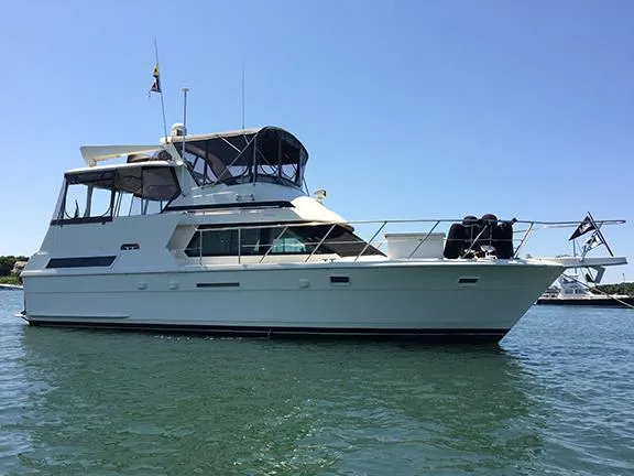 Slide: The Image of 1991 Hatteras 40 Motor Yacht on calm water, side view. - 15
