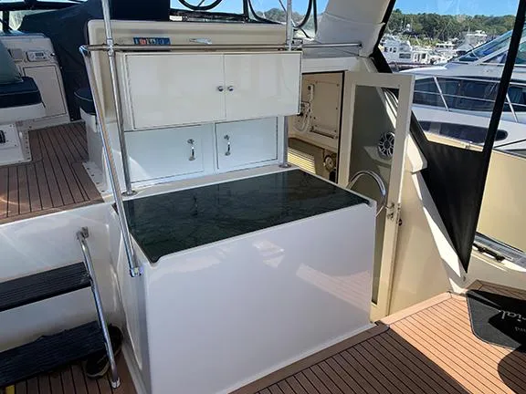 Slide: The Image of 1991 Hatteras 40 Motor Yacht interior with cabinets and seating area. - 17