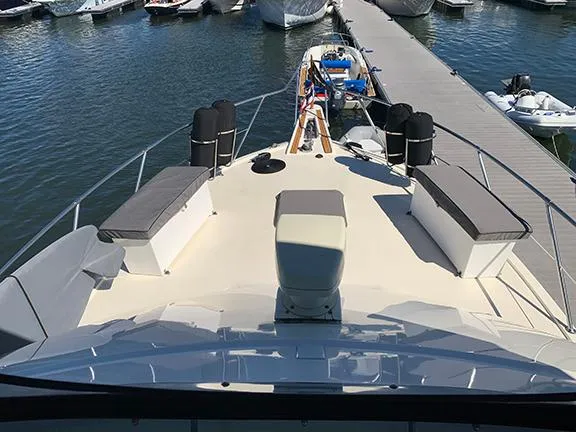Slide: The Image of 1991 Hatteras 40 Motor Yacht docked at a marina. - 35