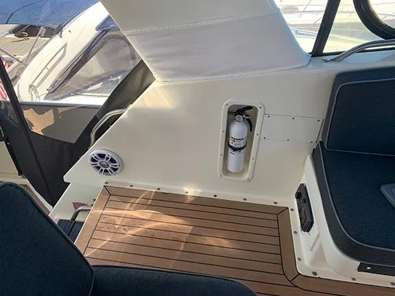 Slide: The Image of Interior of 1991 Hatteras 40 Motor Yacht with wooden flooring and fire extinguisher. - 40