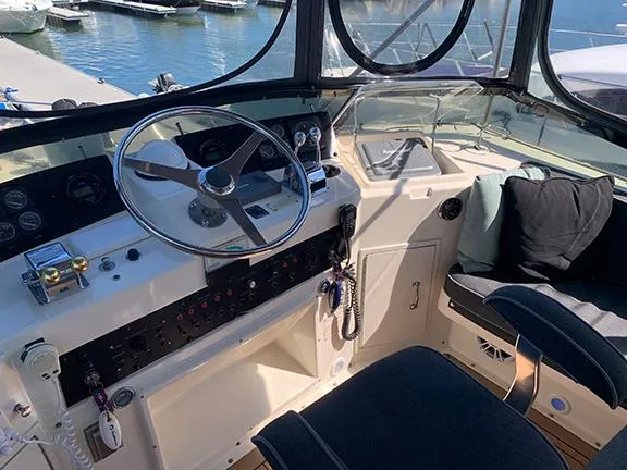 Slide: The Image of 1991 Hatteras 40 Motor Yacht helm station with steering wheel and control panel. - 42