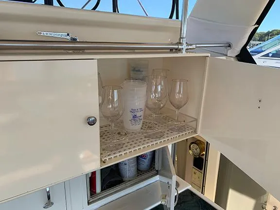 Slide: The Image of Cabinet with glassware on a 1991 Hatteras 40 Motor Yacht. - 45