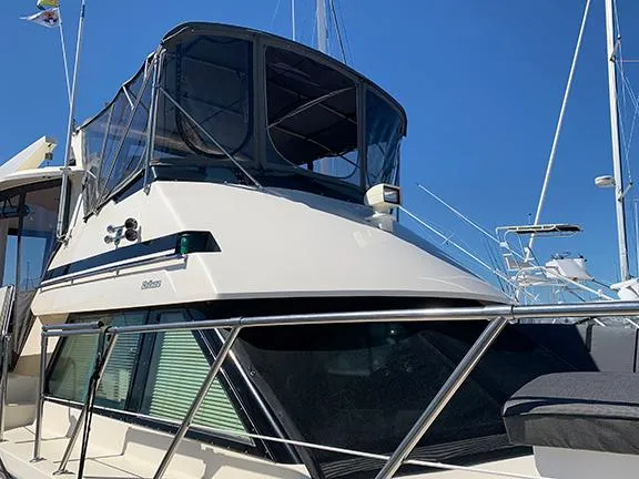 Slide: The Image of 1991 Hatteras 40 Motor Yacht with enclosed flybridge in marina. - 6