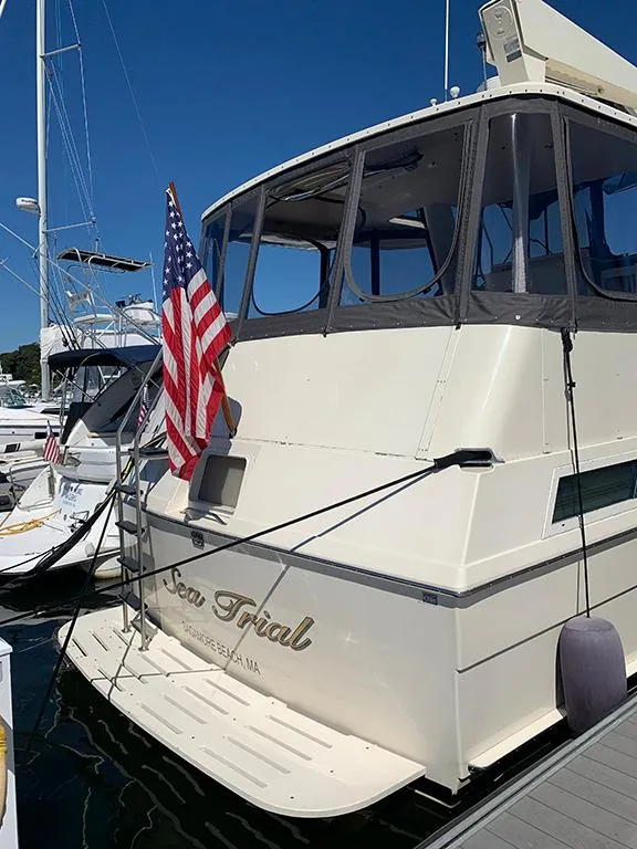Slide: The Image of 1991 Hatteras 40 Motor Yacht docked with American flag. - 7
