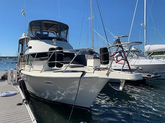 Slide: The Image of 1991 Hatteras 40 Motor Yacht docked at marina on a sunny day. - 8