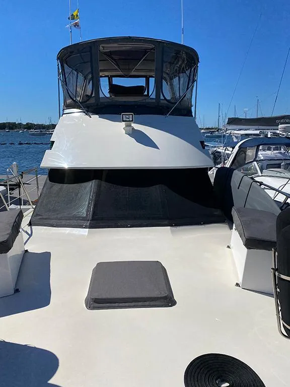 Slide: The Image of 1991 Hatteras 40 Motor Yacht docked at a marina on a sunny day. - 9