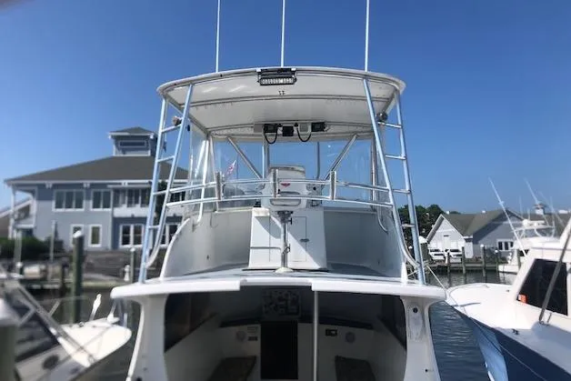 Slide: The Image of 1979 Custom Carolina Sportfish 35 docked at a marina, front view. - 11