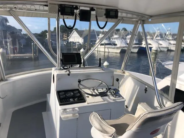 Slide: The Image of 1979 Custom Carolina Sportfish 35 helm station with marina view. - 13