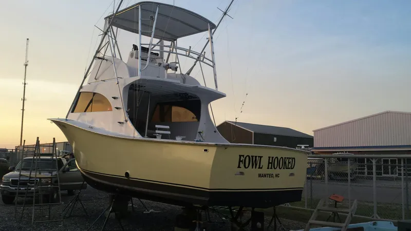Slide: The Image of 1979 Custom Carolina Sportfish 35 boat named Fowl Hooked in a marina. - 16