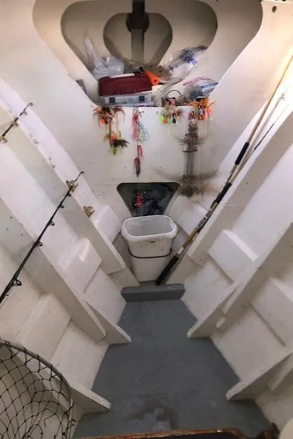 Slide: The Image of Interior of 1979 Custom Carolina Sportfish 35 with fishing gear and storage. - 8