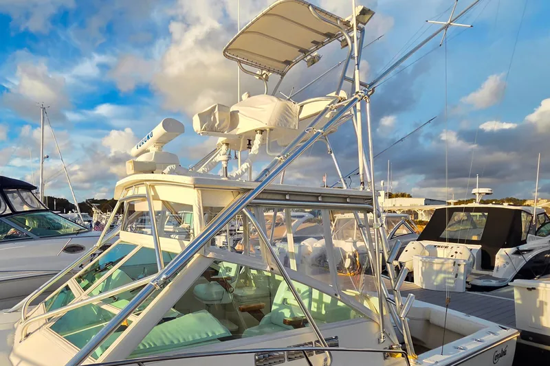 Slide: The Image of 2007 Carolina Classic 28 Express boat docked under a vibrant sky. - 24